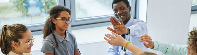 image of teacher and pupils in discussion